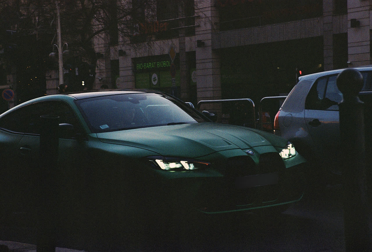 Green BMW M4, plate blurred