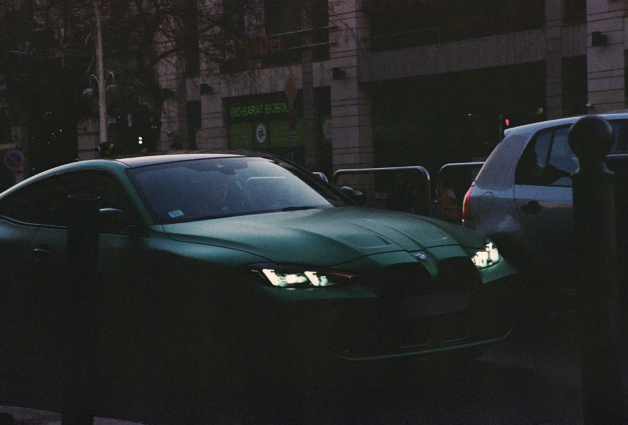 Green BMW M4, plate blurred
